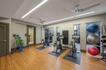 24-Hour fitness center with spin and yoga room featuring fitness on demand virtual workouts